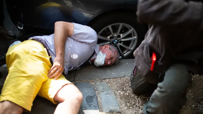 A protester on the ground after fighting with another demonstrator
