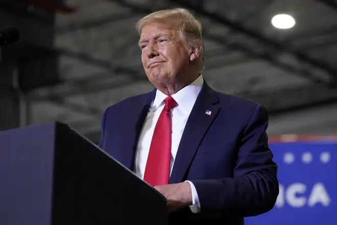 President Donald Trump reacts to the crowd as he speaks at a rally at Xtreme Manufacturing in Henderson, Nevada