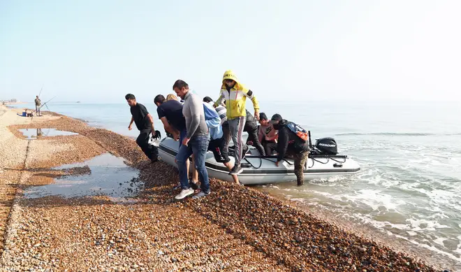 The group of men, believed to be migrants, arriving in the UK