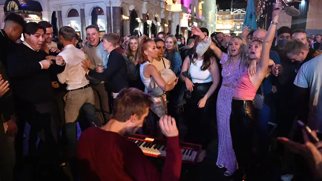 People enjoy a night out in Leicester Square ahead of the 'rule of six' coming into effect