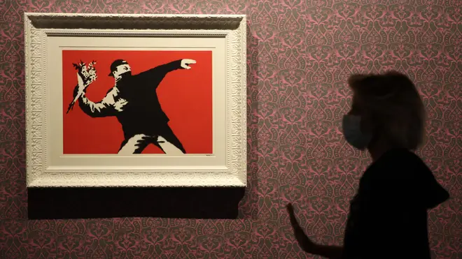 Banksy's Flower Thrower hangs in a gallery