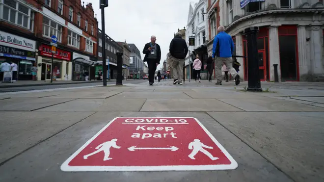 File photo: People walk on the street in central Bolton, Greater Manchester