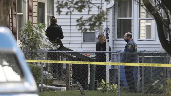 Investigators behind police tape at the scene of a shooting in New York state