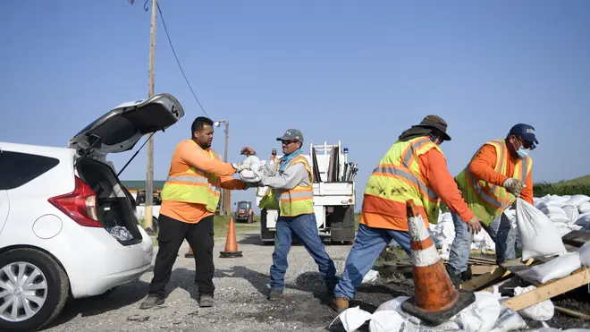 Workers in Texas load free sandbags for residents ahead of Tropical Storm Beta