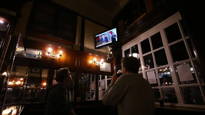 Pub customers watch Boris Johnson