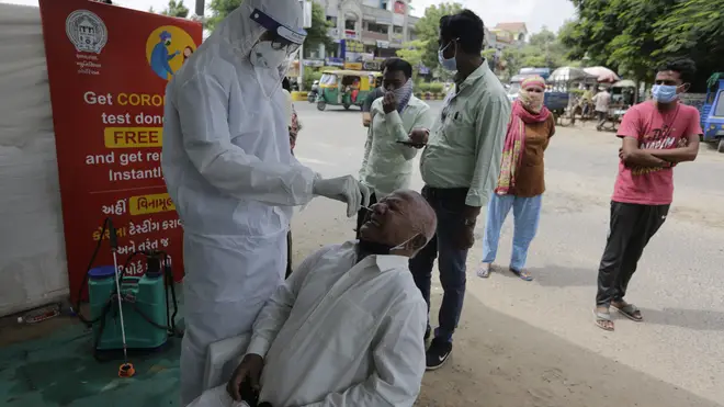 A health worker takes a nasal swab sample to test for Covid-19 in Ahmedabad, India