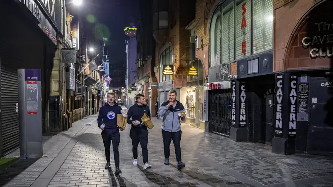 Three men walk past the famous Cavern Club in Liverpool city centre (Peter Byrne/PA)