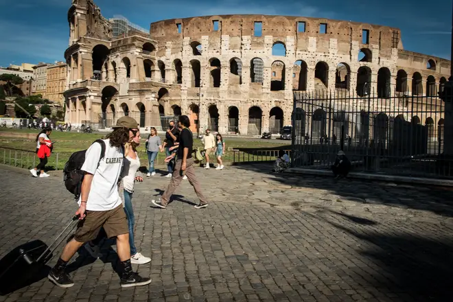File photo: Tourists walk near the Colosseum in Rome