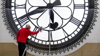 Dougie Cook, from the housekeeping team, cleans the St Enoch Clock in the Antonine Centre in Cumbernauld