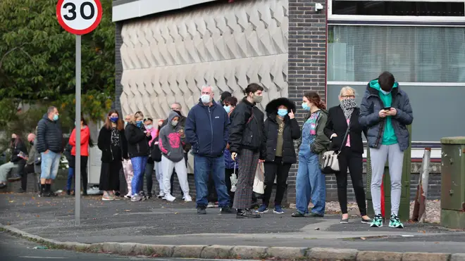 People wait at a testing centre in Liverpool