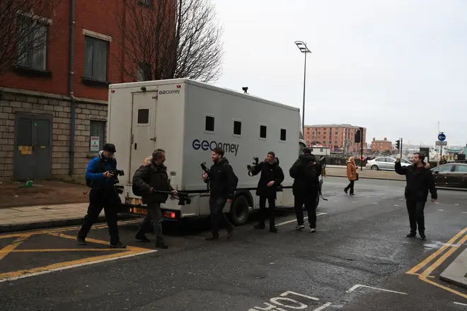 Photographers take pictures through the window of a GEOAmey van leaving Liverpool Crown Court after the sentencing of Barry Bennell