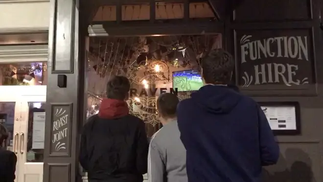 The football fans were relegated to watching penalties through the window