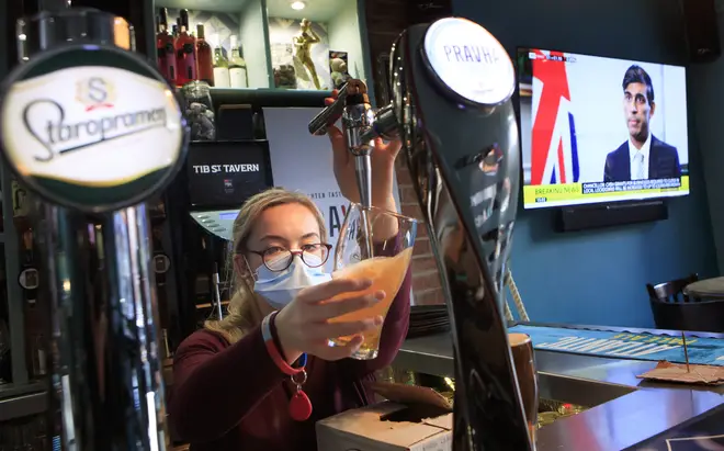 An employee pulls a pint in the Tib Street Tavern in Manchester, as Chancellor of the Exchequer Rishi Sunak announces the new furlough scheme