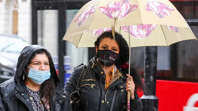 Women wearing face masks as doctors say they should be mandatory outdoors and in offices