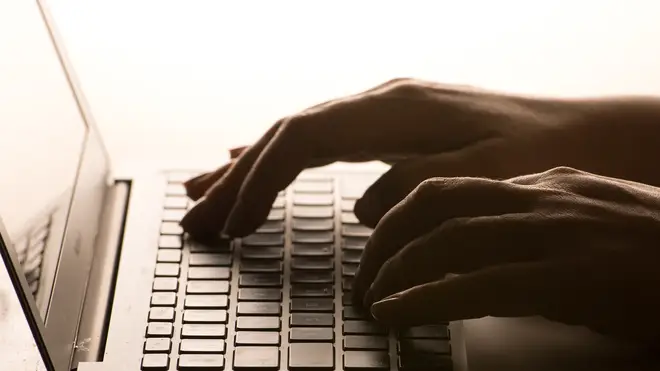 A woman’s hands on a laptop keyboard
