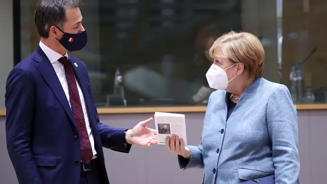 German Chancellor Angela Merkel, right, speaks with Belgium's Prime Minister Alexander De Croo