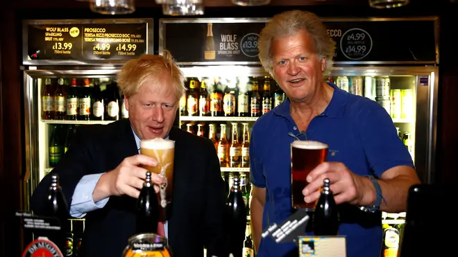 Boris Johnson and Tim Martin behind the bar at a Wetherspoon pub