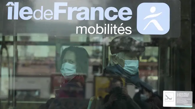 People in coronavirus masks on a bus in Paris