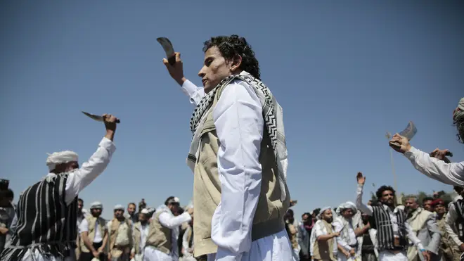 A Yemeni prisoner, centre, performs a traditional dance during his arrival after being released by the Saudi-led coalition (Hani Mohammed/AP)