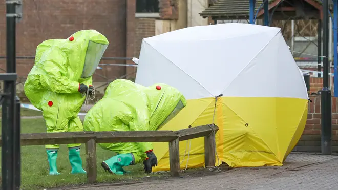 Police in hazmat suits at the site of the poisoning in April 2018