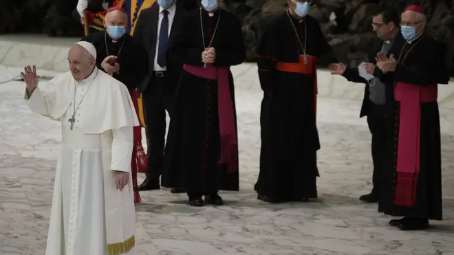 Pope Francis waves to faithful at the end of the weekly general audience in the Paul VI hall at the Vatican
