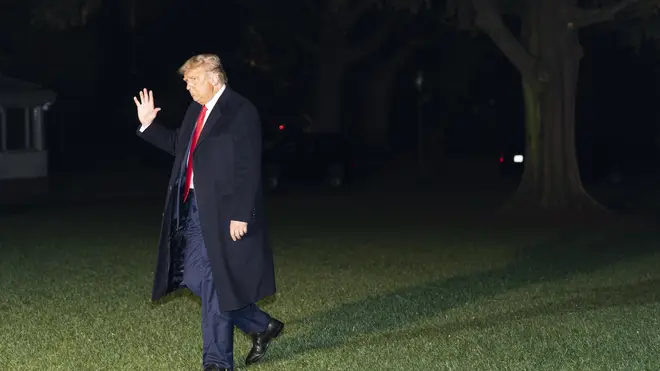 President Donald Trump waves as he walks on the South Lawn of the White House