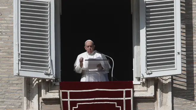 Pope Francis delivers his message during the Angelus noon prayer from the window of his studio overlooking St Peter’s Square