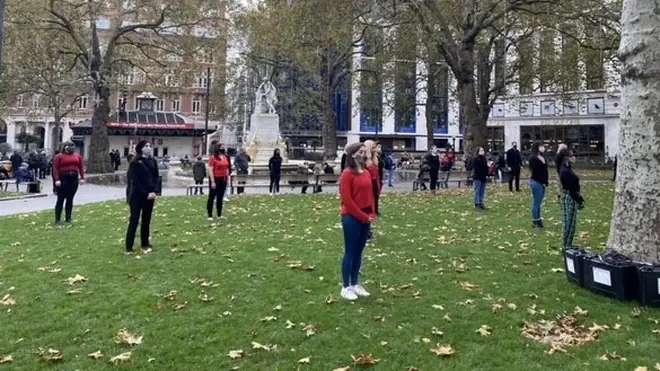 The protesters were seen standing socially-distanced with face masks on in Leicester Square