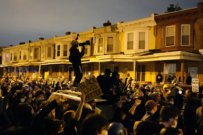Protesters confront police during a march in Philadelphia on Tuesday