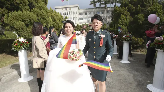 Lesbian couple Chen Ying-hsuan, right, and Li Li-chen attend a military mass weddings ceremony in Taoyuan city, northern Taiwan (Chiang Ying-ying/AP)