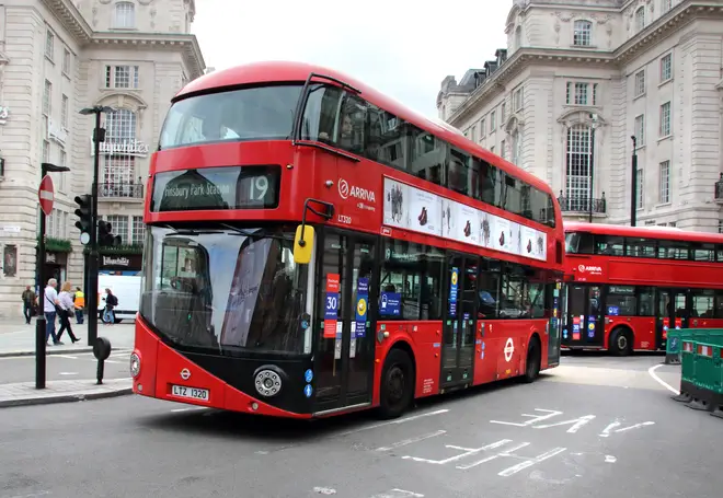 London buses turn the corner onto Piccadilly Circus