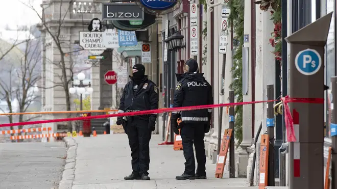 Police officers guard the site of the multiple stabbing