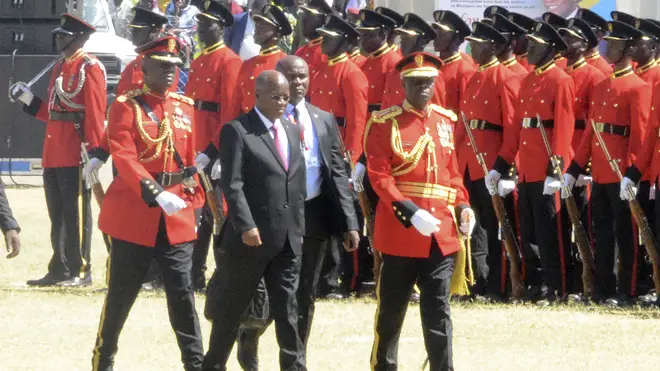 Tanzanian president President John Magufuli, middle, walks to the dais after inspecting a guard of honour (Stringer/AP)