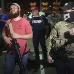 Armed Trump supporters stand outside of Maricopa County Recorder's Office