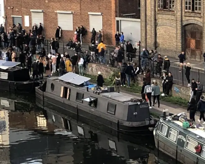 A large crowd near a canal in east London