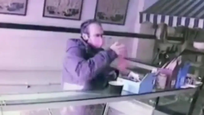 This is the moment the thief stole the poppy box from the counter of the butcher's shop