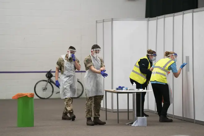 File photo: Members of the armed forces help to test the public at Liverpool Tennis Centre on the first day of the pilot scheme of mass testing in Liverpool