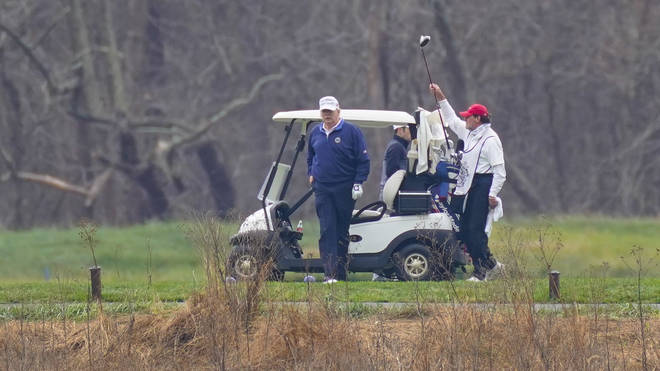 Trump, seen golfing on Sunday, is said to be blocking Biden's team from being briefed on the pandemic