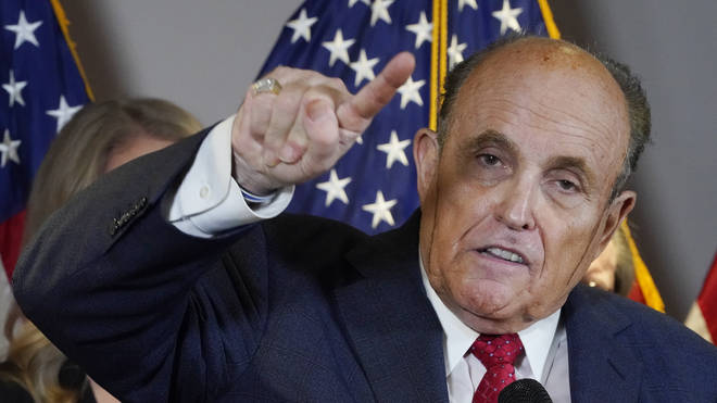 Mr Giuliani had two streaks of sweat mixed with apparent hair dye on his cheeks
