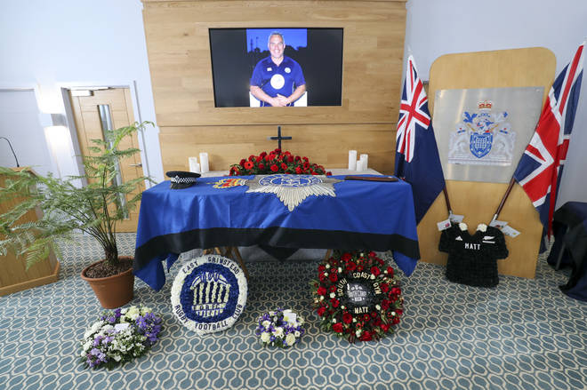 The coffin and floral tributes in the church before the funeral service of police officer Sergeant Matt Ratana