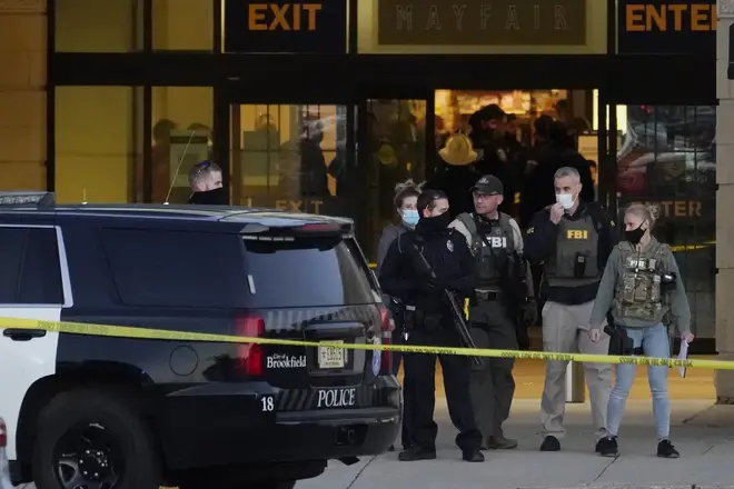 FBI officials and police stand outside the Mayfair Mall after a shooting