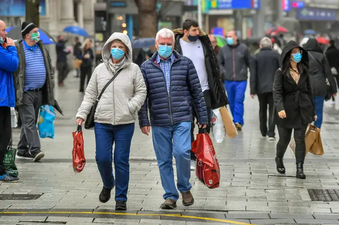 Shoppers carry bags in the centre of Cardiff where shops are open