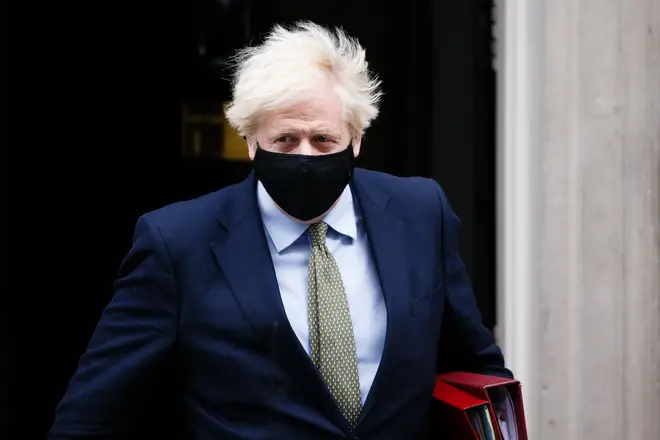 British Prime Minister Boris Johnson leaves 10 Downing Street wearing a face mask