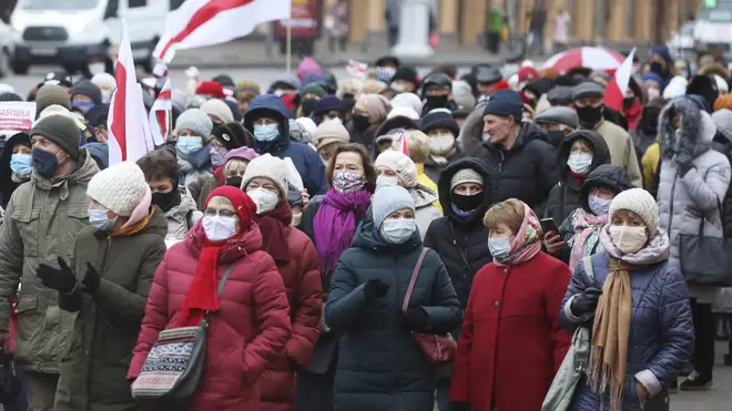 Belarus pensioners wearing face masks to protect against coronavirus attend an opposition rally (AP)