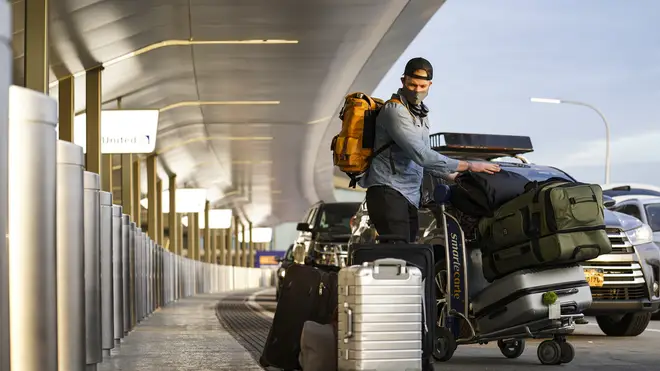 Travellrs arrive at Terminal C at LaGuardia Airport, New York (John Minchillo/AP)