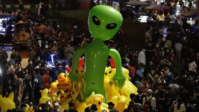 Protesters gather balloons shaped like aliens – to mock accusations that foreigners fund and direct their movementt