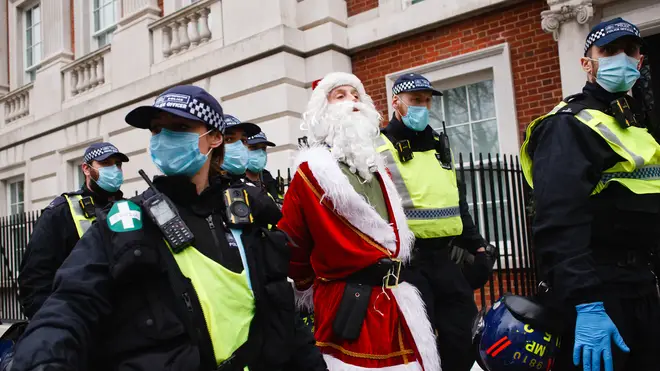 A protester dressed as Santa Claus was pictured in handcuffs during the demonstration