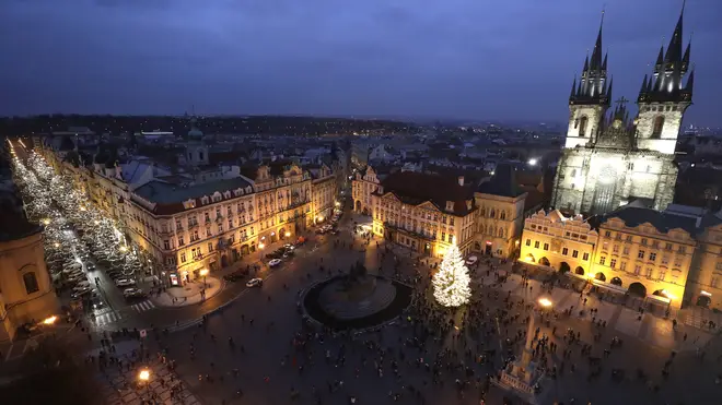 A Christmas tree illuminates the Old Town Square in Prague
