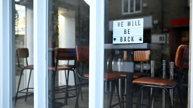 A sign in the window of a closed cafe reads 'We Will Be Back' as England enters a second lockdown