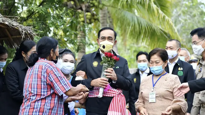 Thailand’s prime minister Prayuth Chan-ocha receives flowers from well wishers in Samut Songkhram province, Thailand (Spokesman's Office/AP)